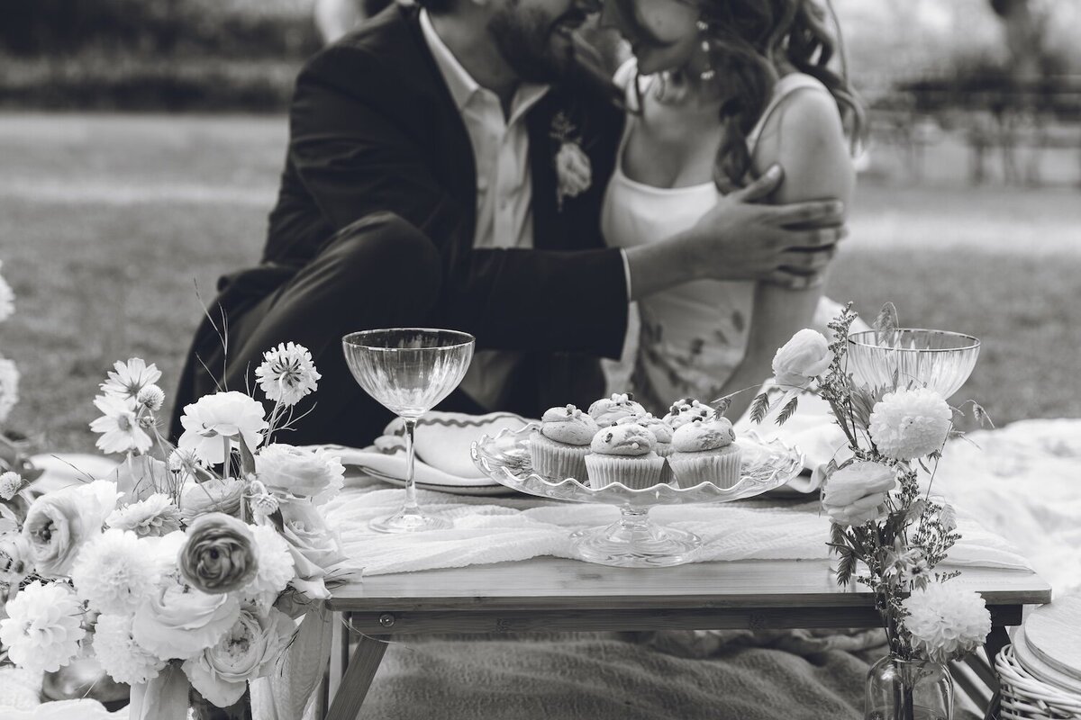 Bride and groom sharing a romantic kiss with champagne