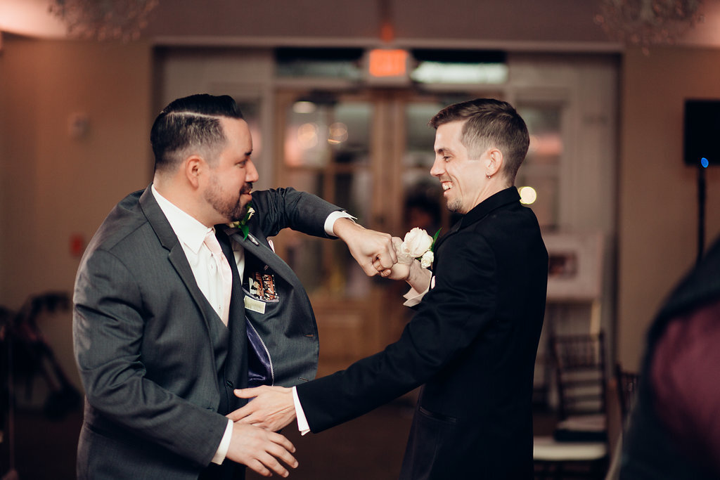 Wedding Photograph Of Groom Smiling While Dancing With a Man In Gray Suit Los Angeles