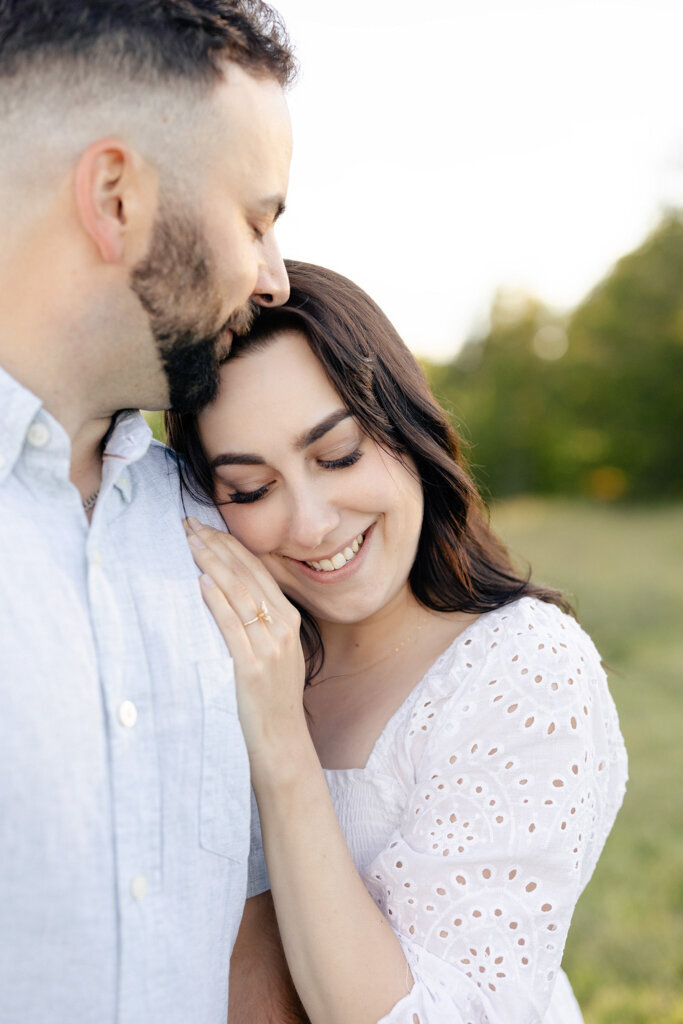 Couple embracing during engagement session, captured by Lorissa Lee Photography. Featured on Brontë Bride.