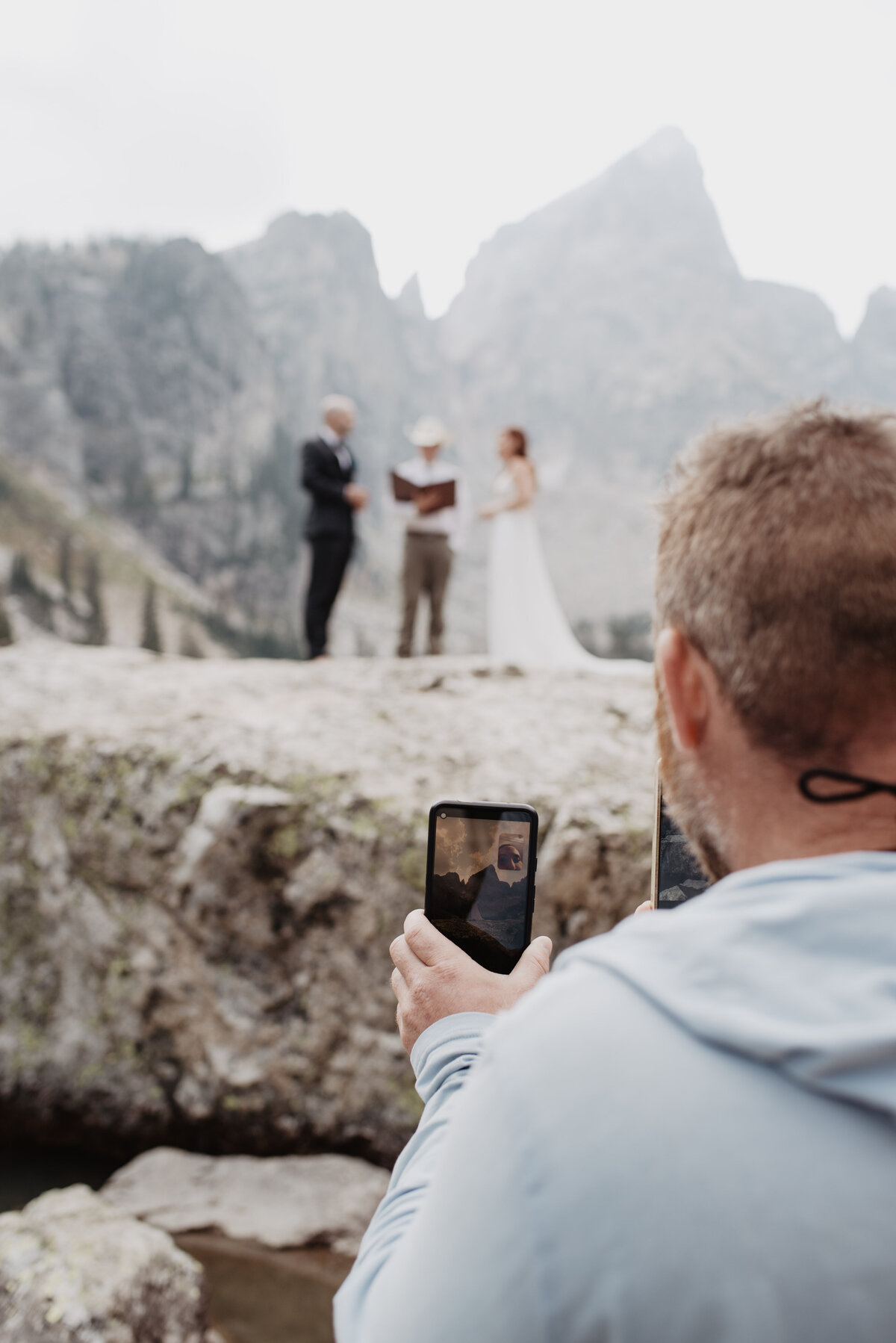 Jackson Hole photographers capture man taking a picture of wedding ceremony
