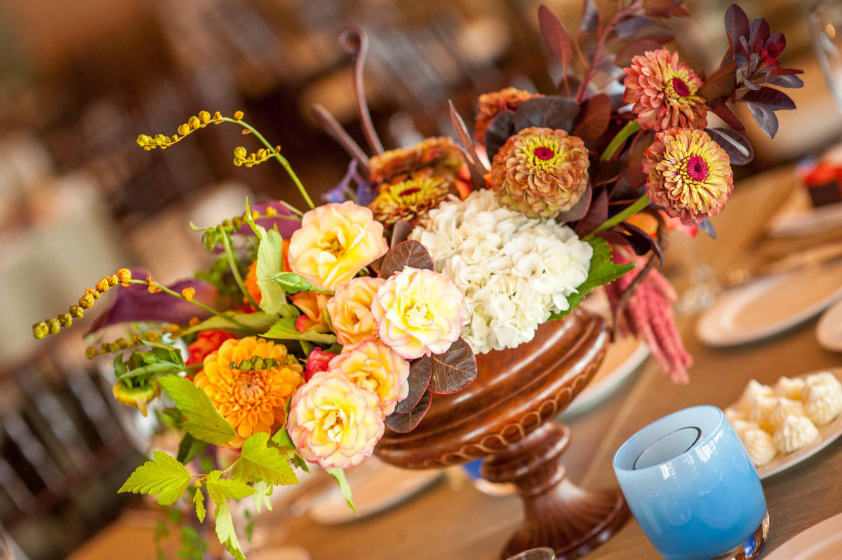 fall centerpiece in copper urn and blue glassybaby candle