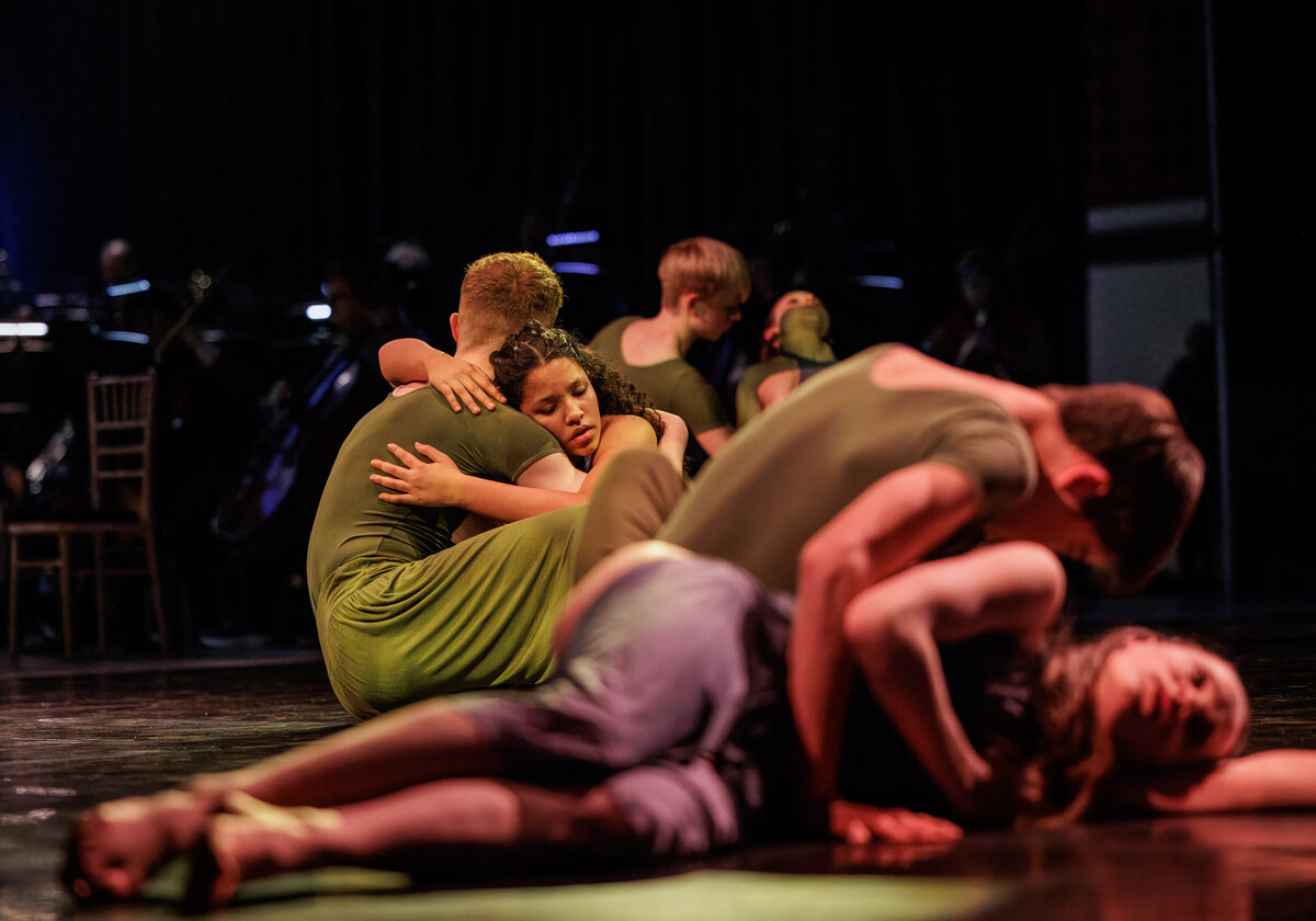 Image of a dance production of The Rite of Spring by The Workshop Studios and Norwich Philharmonic Orchestra. Taken by Norwich event photographer Claire Howes. Two dancers are embracing on the floor.