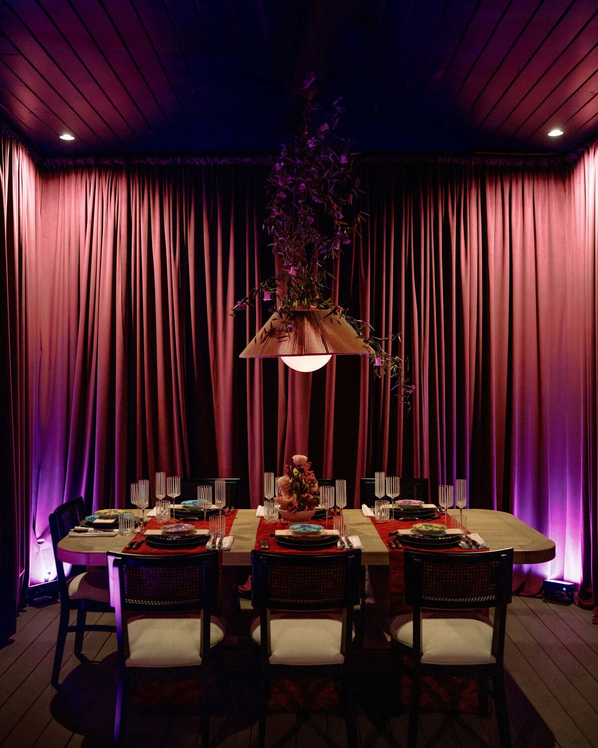 Moody, editorial-style tablescape with candlelit details and dramatic uplighting from a styled event in Nashville, Tennessee.