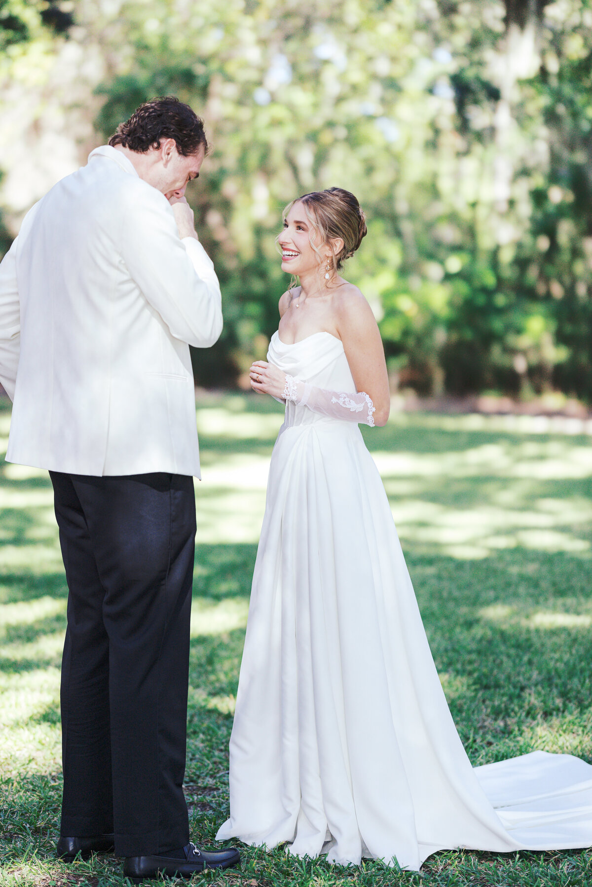Bride smiles at groom during first look in Charleston