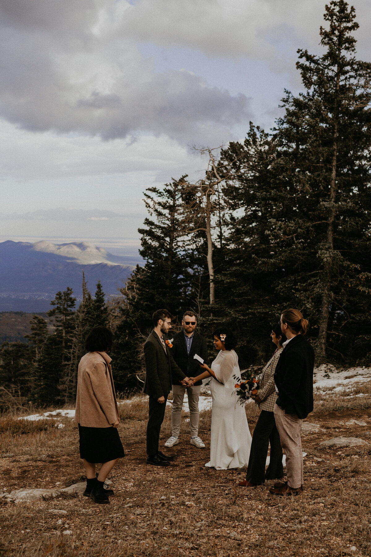 bride and groom exchanging vows and rings on the Sandia Mountains