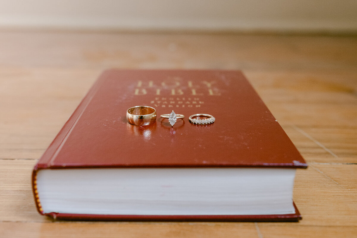 Red heirloom wedding Bible photographed with editorial flat lay styling in a Texas wedding