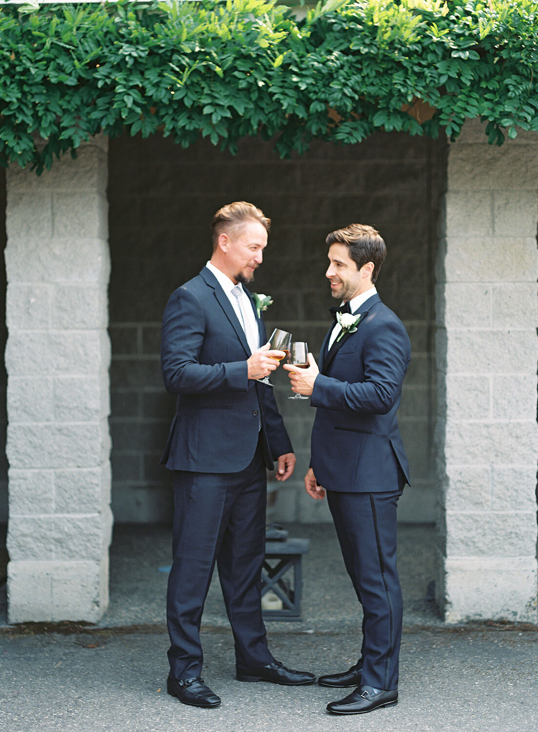 Groom and best man sharing a toast