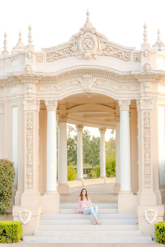 Senior girl sitting on steps at organ pavilion San Diego