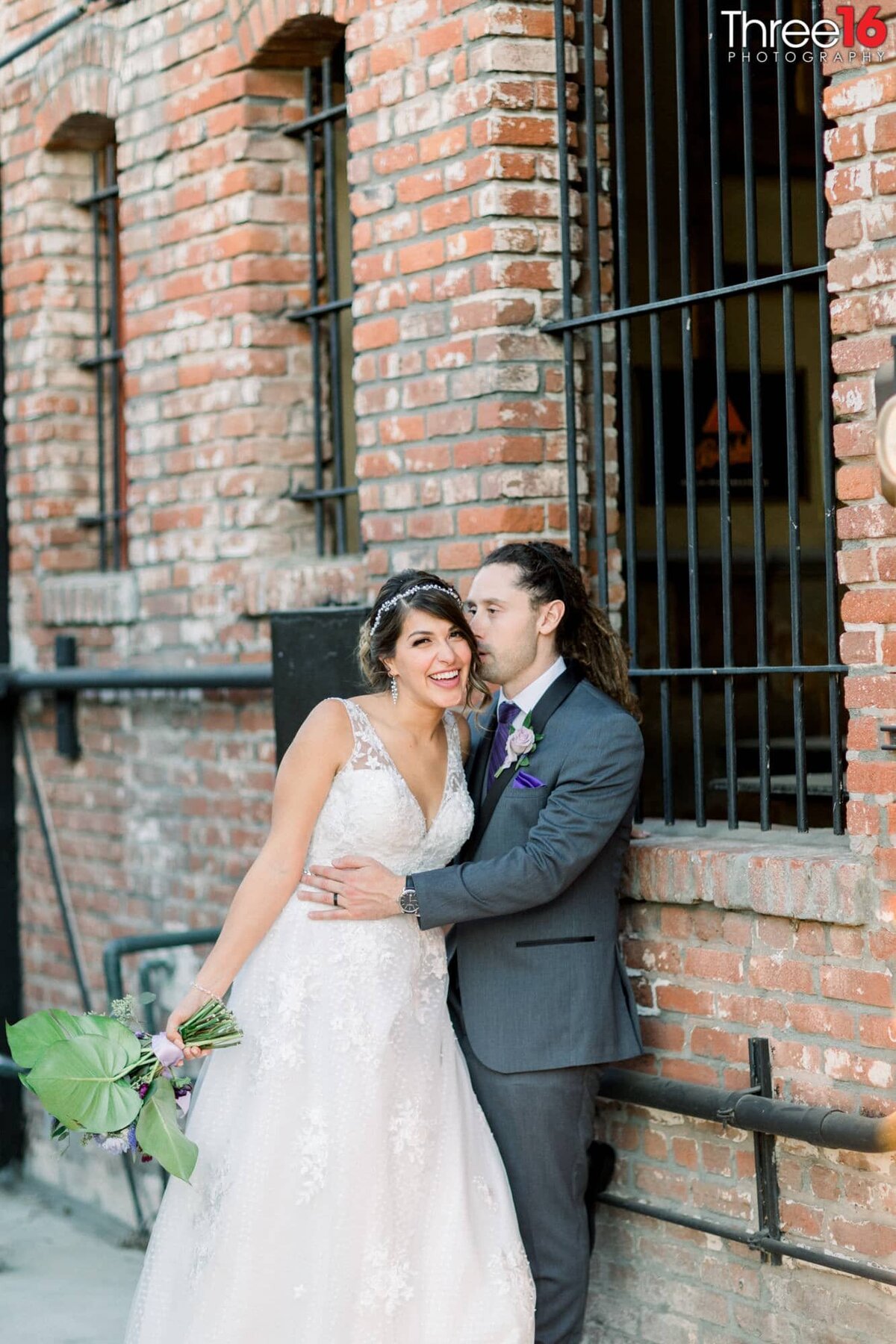 Groom whispers into Bride's ear