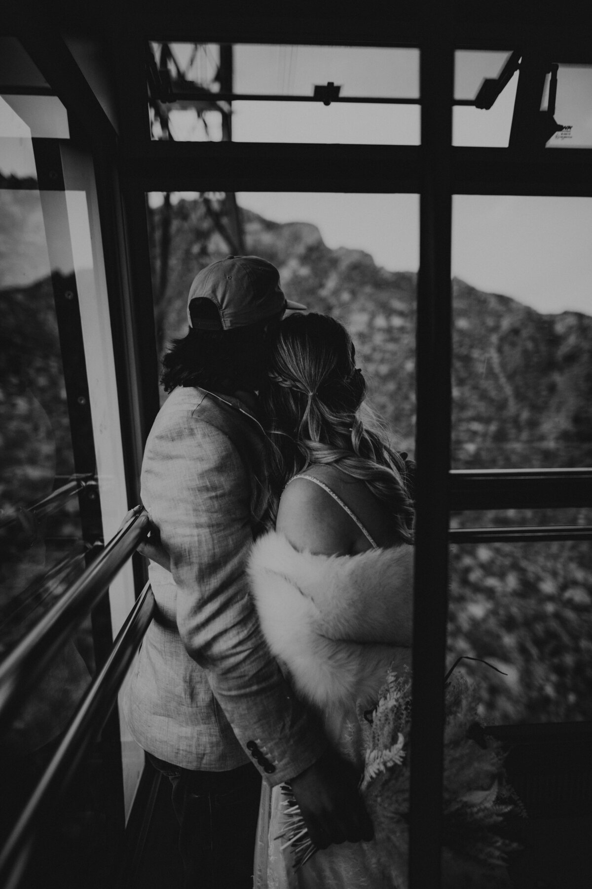 Bride and Groom Riding Sandia Peak Tram after mountain top elopement