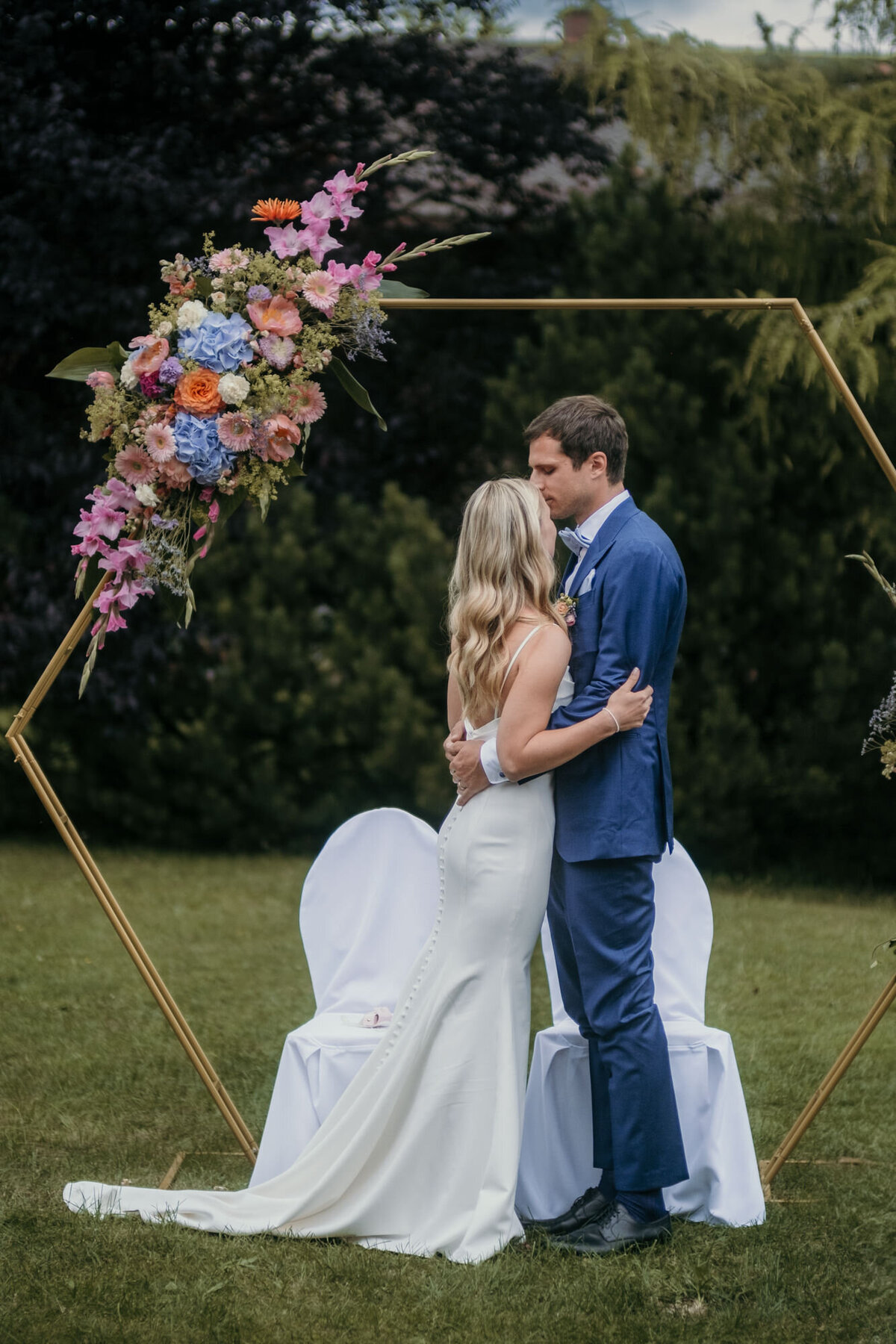 Kissing her forehead, the groom seals their wedding vows in this special moment photography.