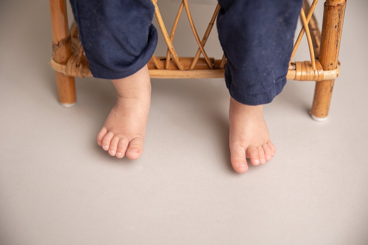 picture of little boy feet as he's sitting in chair