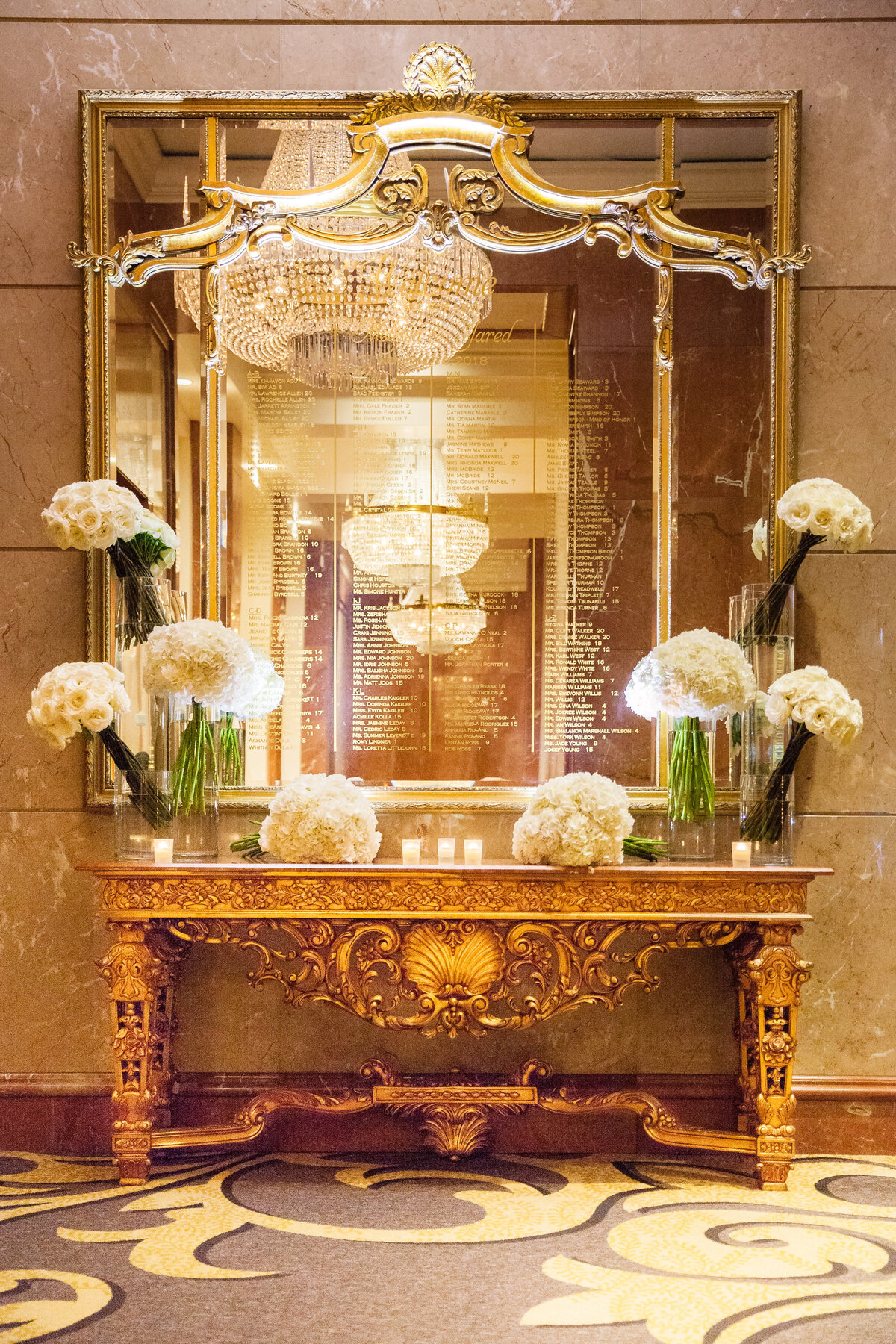 wedding-seating-chart-on-mirror-with-jeff-leathem-inspired-floral-at-four-seasons-atlanta-andre-brown