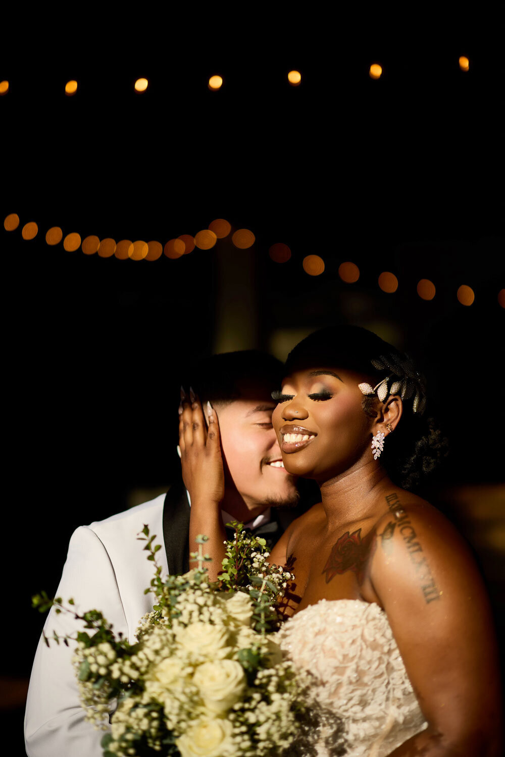Bride smiling while holding grooms face