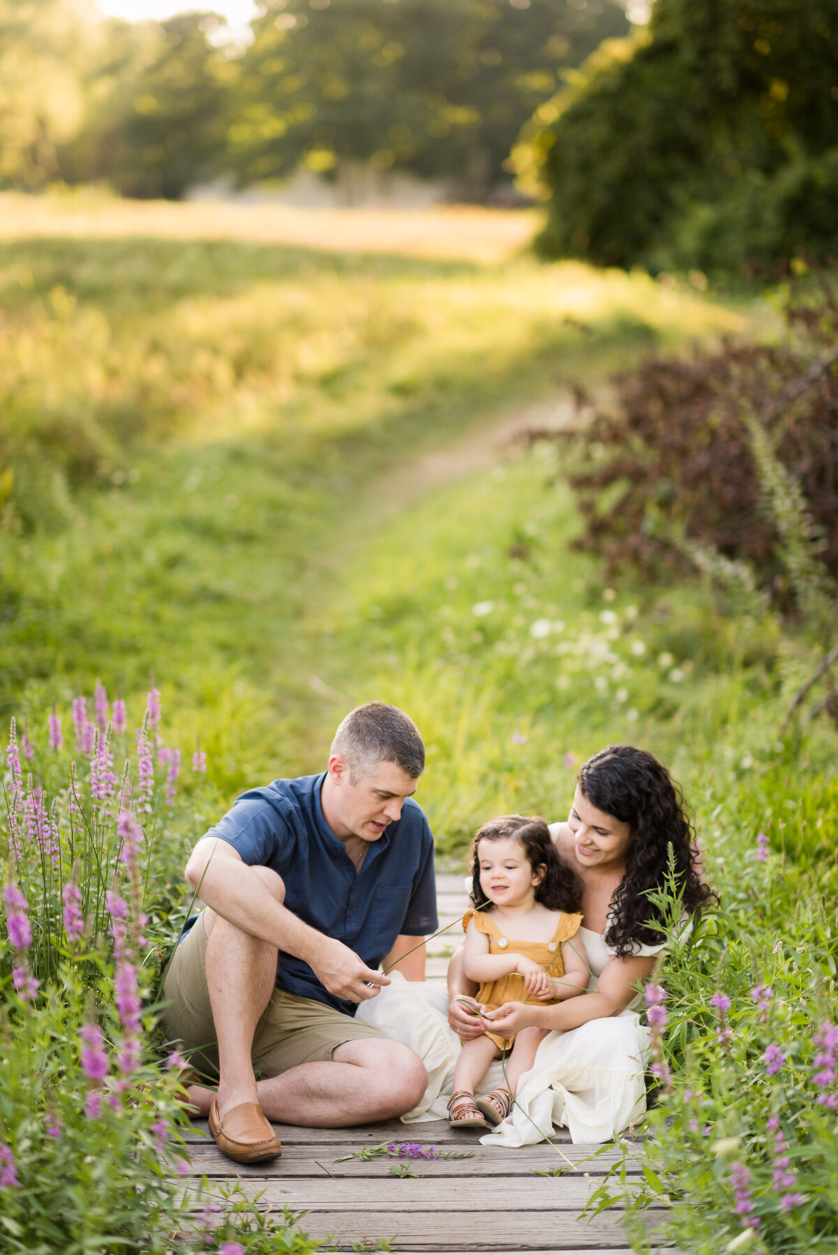 family sitting in a field of flowers
