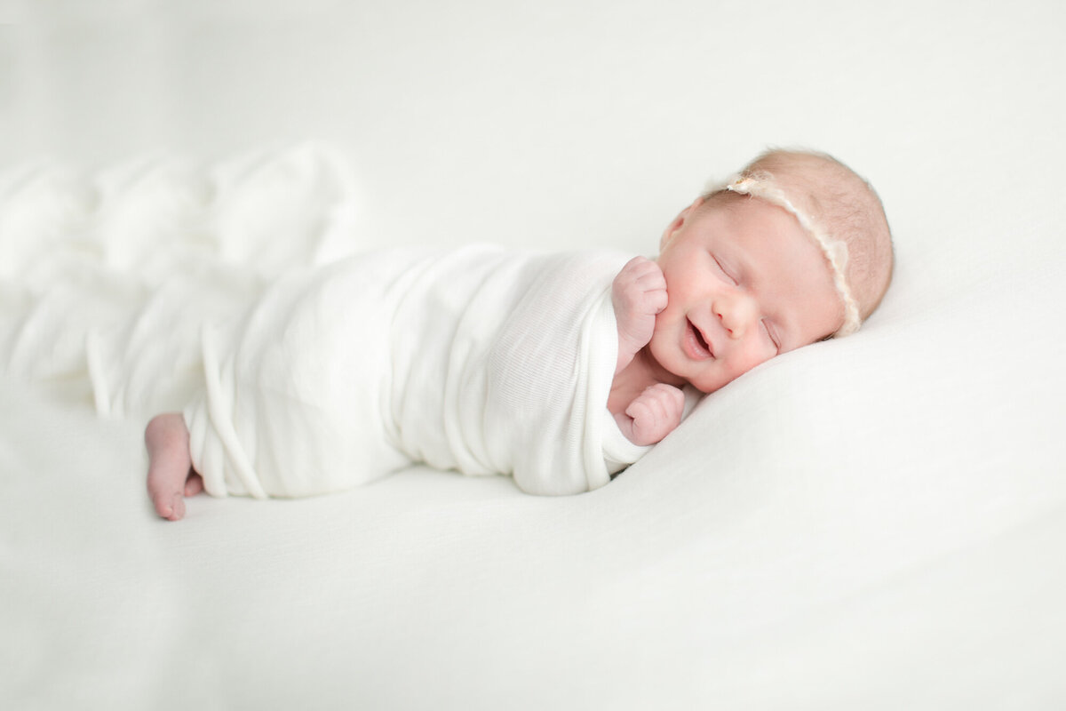 Newborn smiling during boise portrait photography session with Tiffany Hix