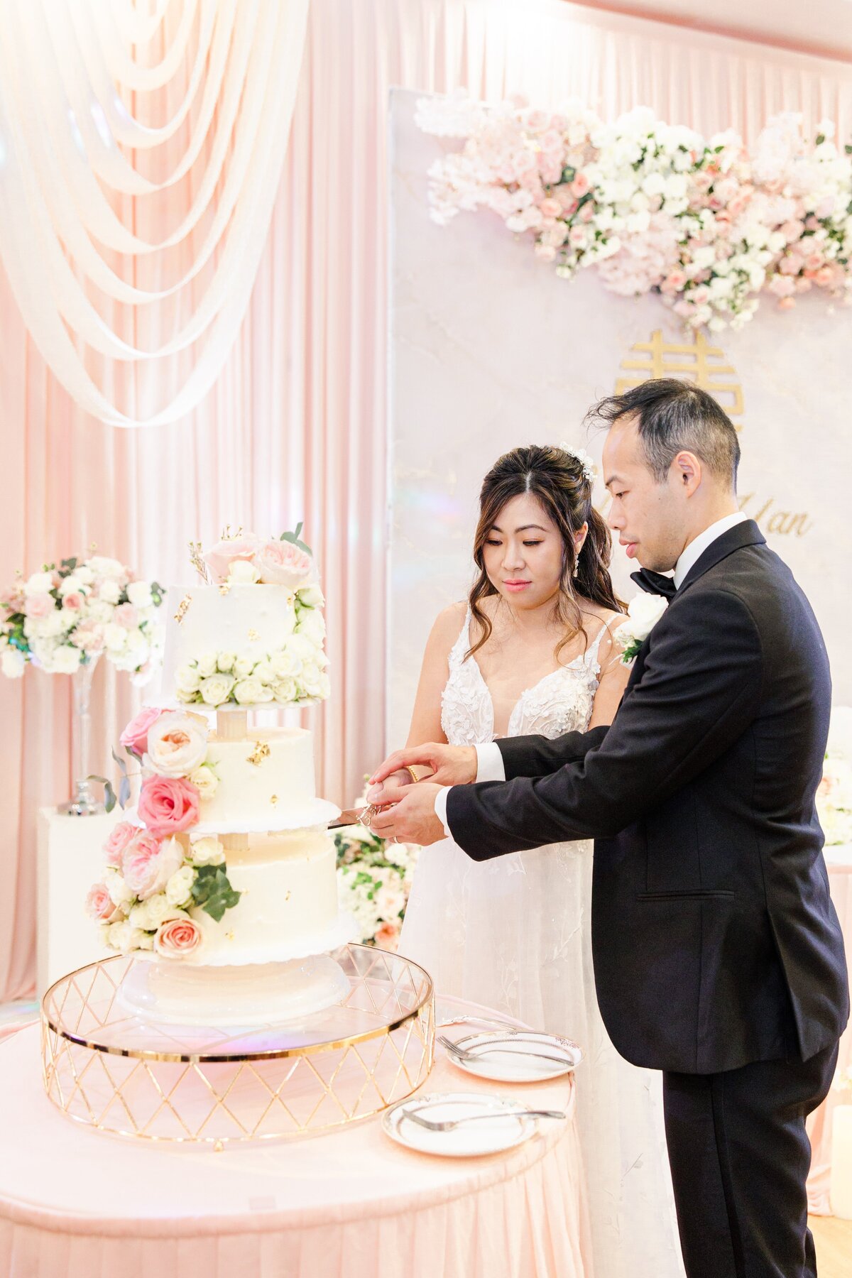 Bride and groom cutting wedding cake representing Boston wedding photos