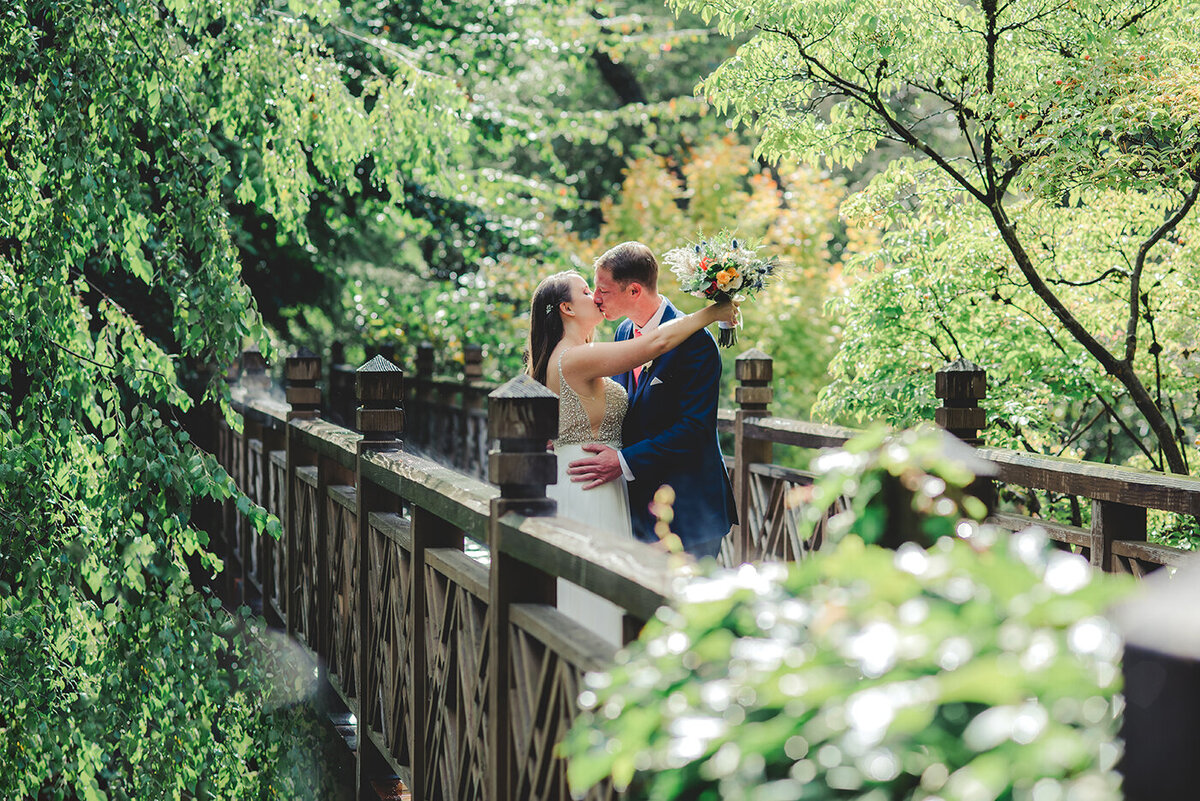 bride and groom on bridge