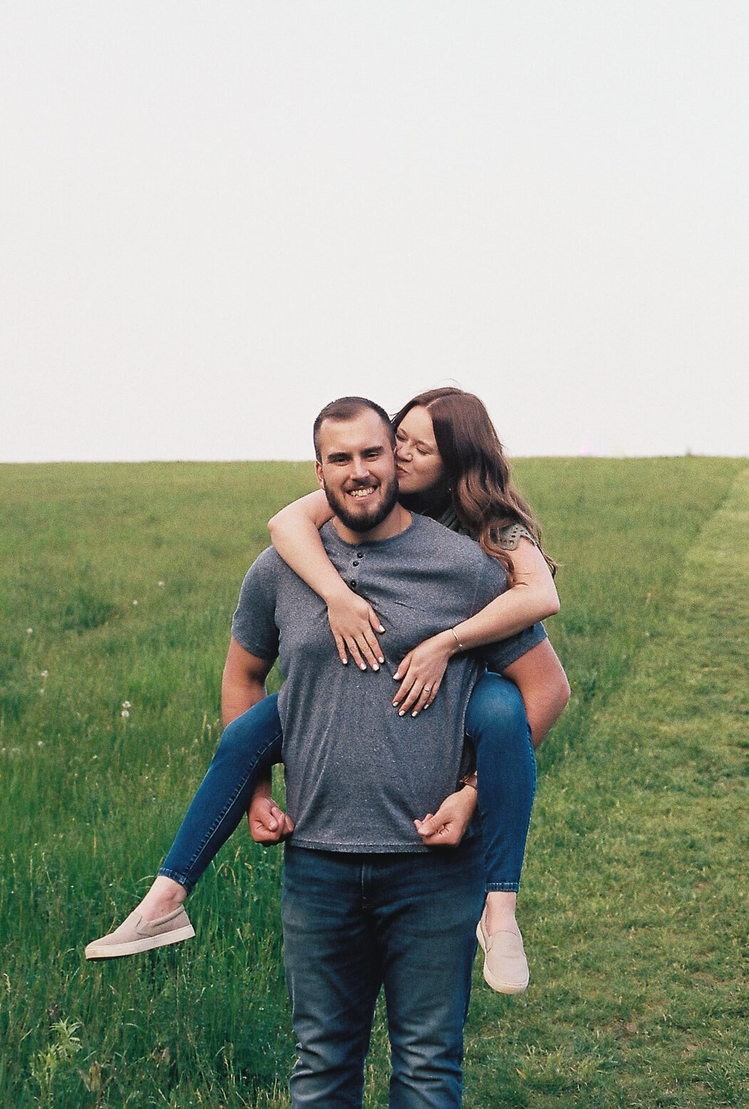 engaged couple in field