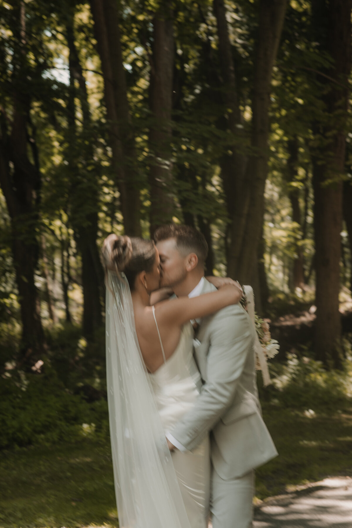 blurry bride and groom kissing