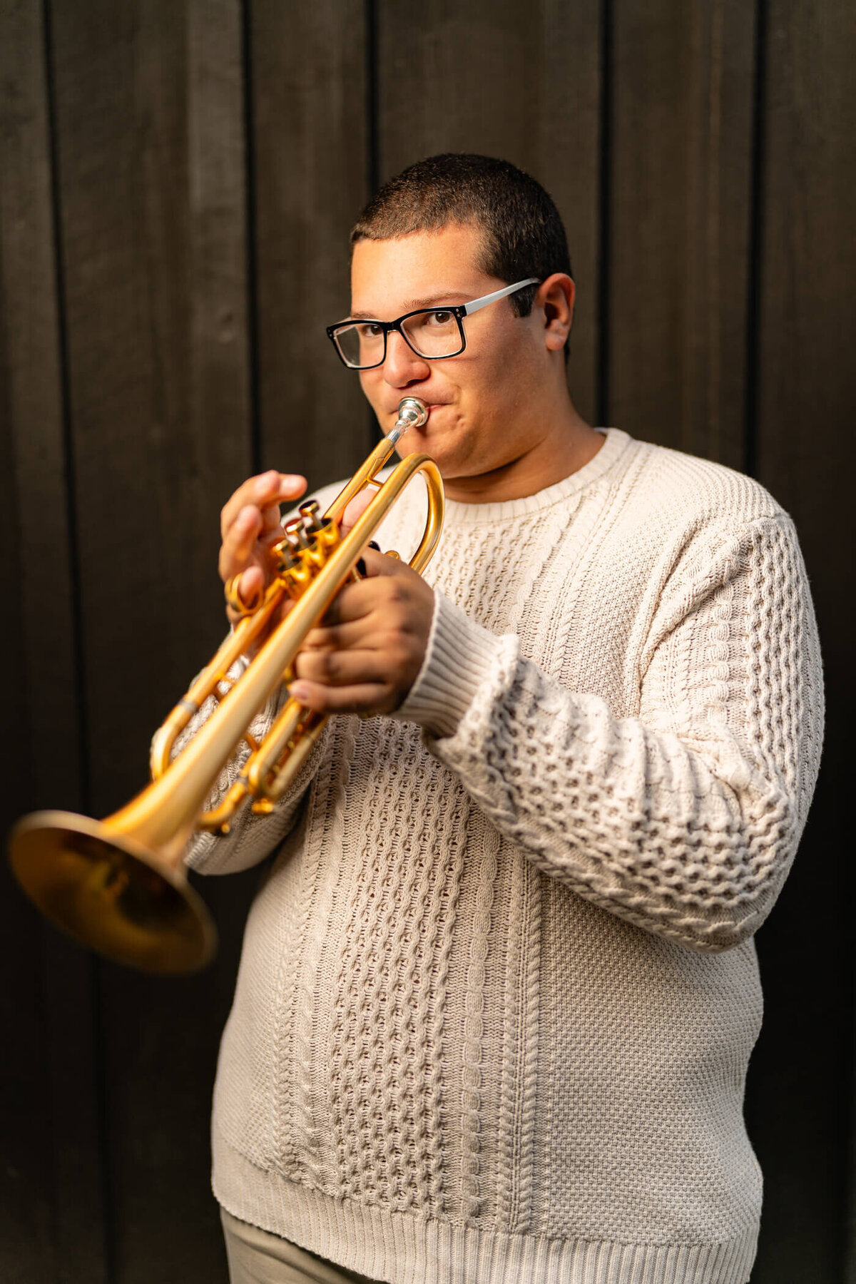 senior picture of a senior playing the trumpet at a park near pittsburgh PA