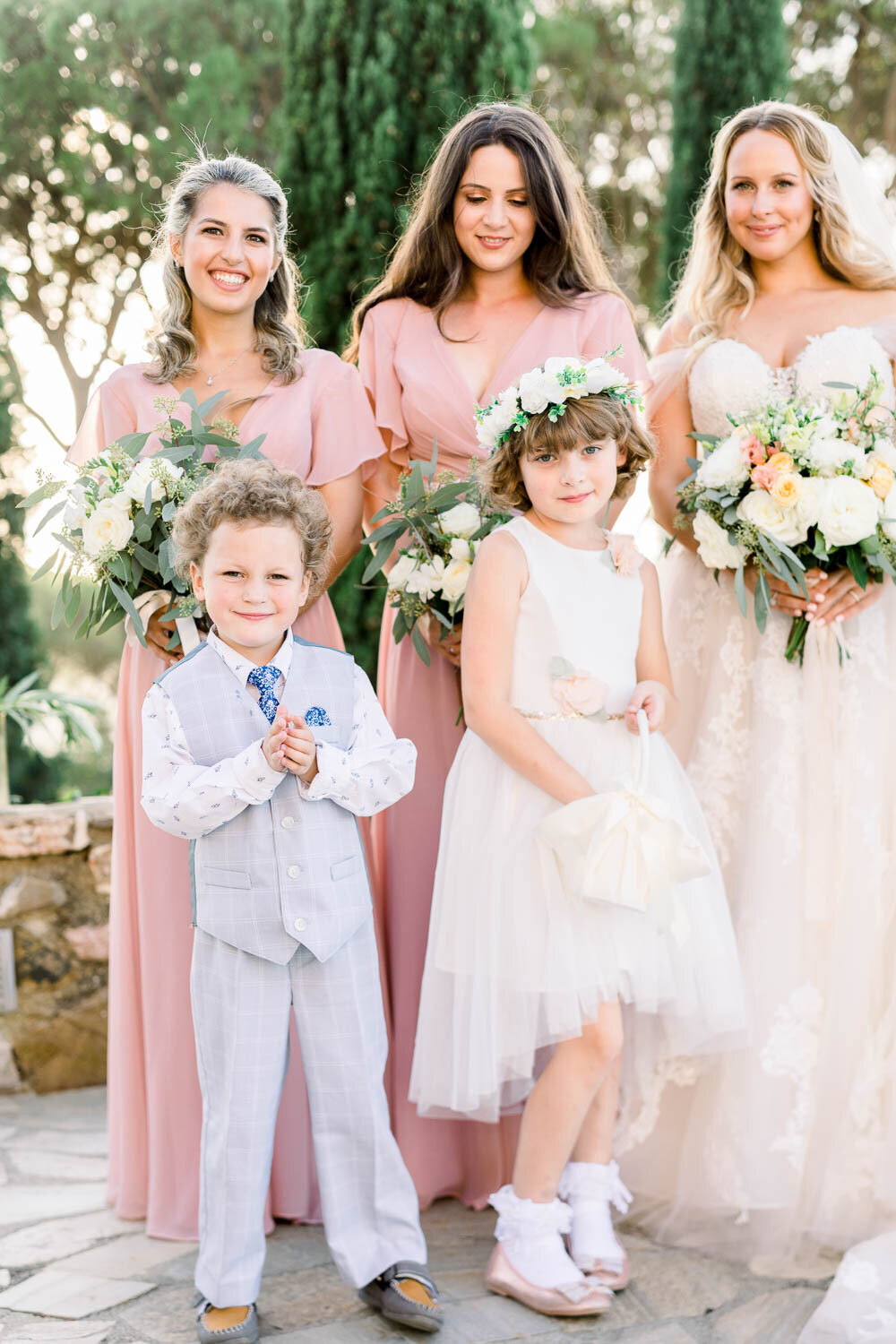 Bride with her bridesmaids and kids at her wedding.