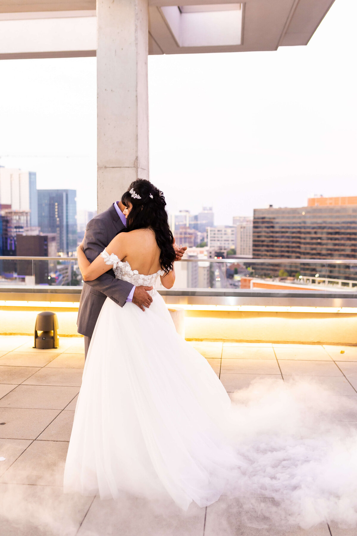 Bride and groom dancing on a rooftop overlooking Nashville