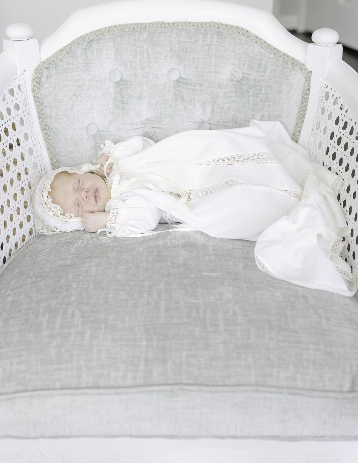 Newborn baby sleeping in antique chair