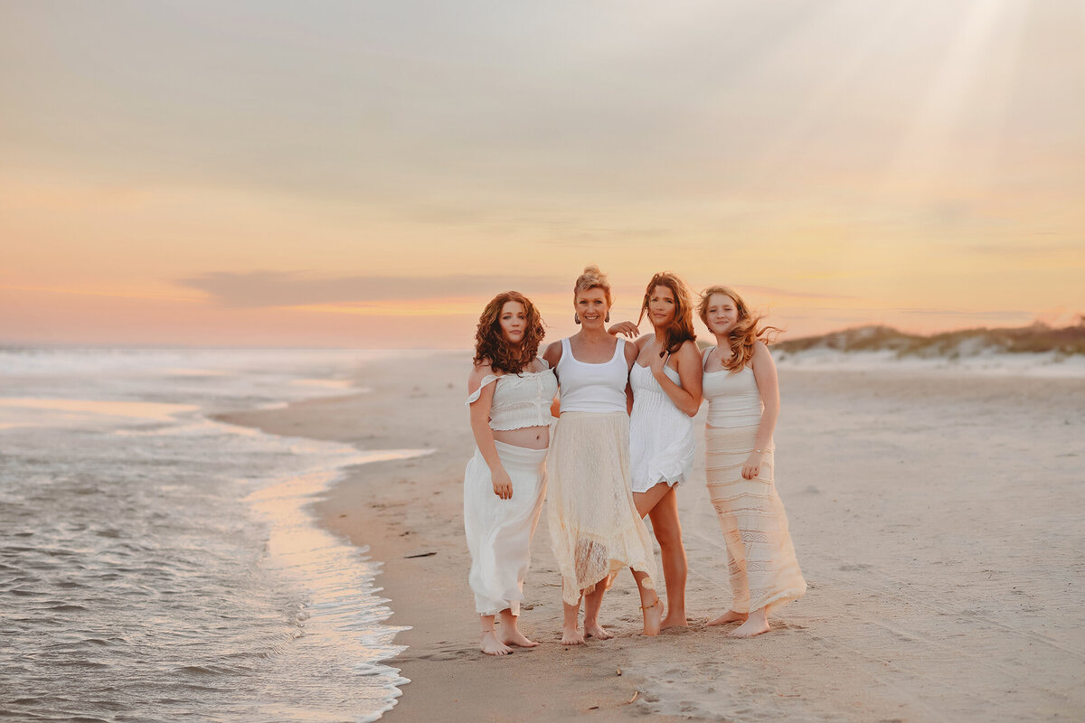 Family poses for Portraits during their Family Photoshoot at Huntington Beach State Park. 