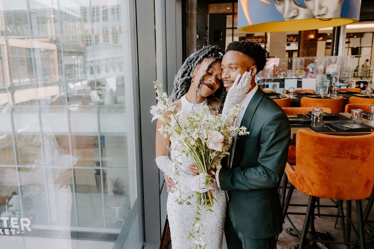 Bride smiling while holding grooms face