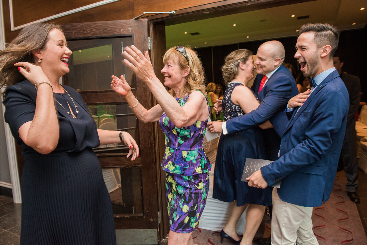 wedding guests congratulating bride in navy dress