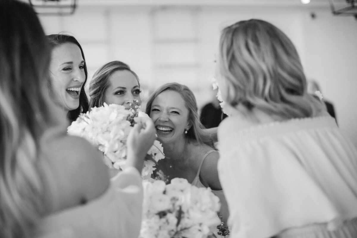 Bridesmaids laugh together and celebrate after Newport wedding ceremony.