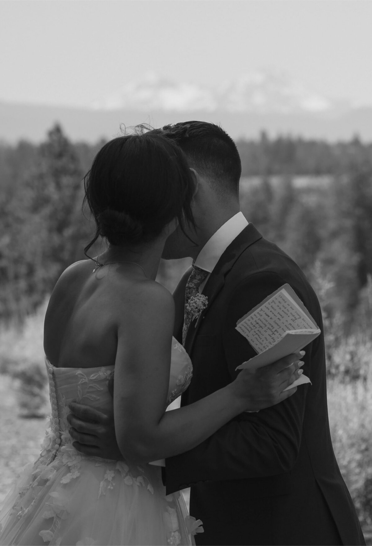 man and woman hug and kiss after they exchanged their vows in the Oregon high desert scenery