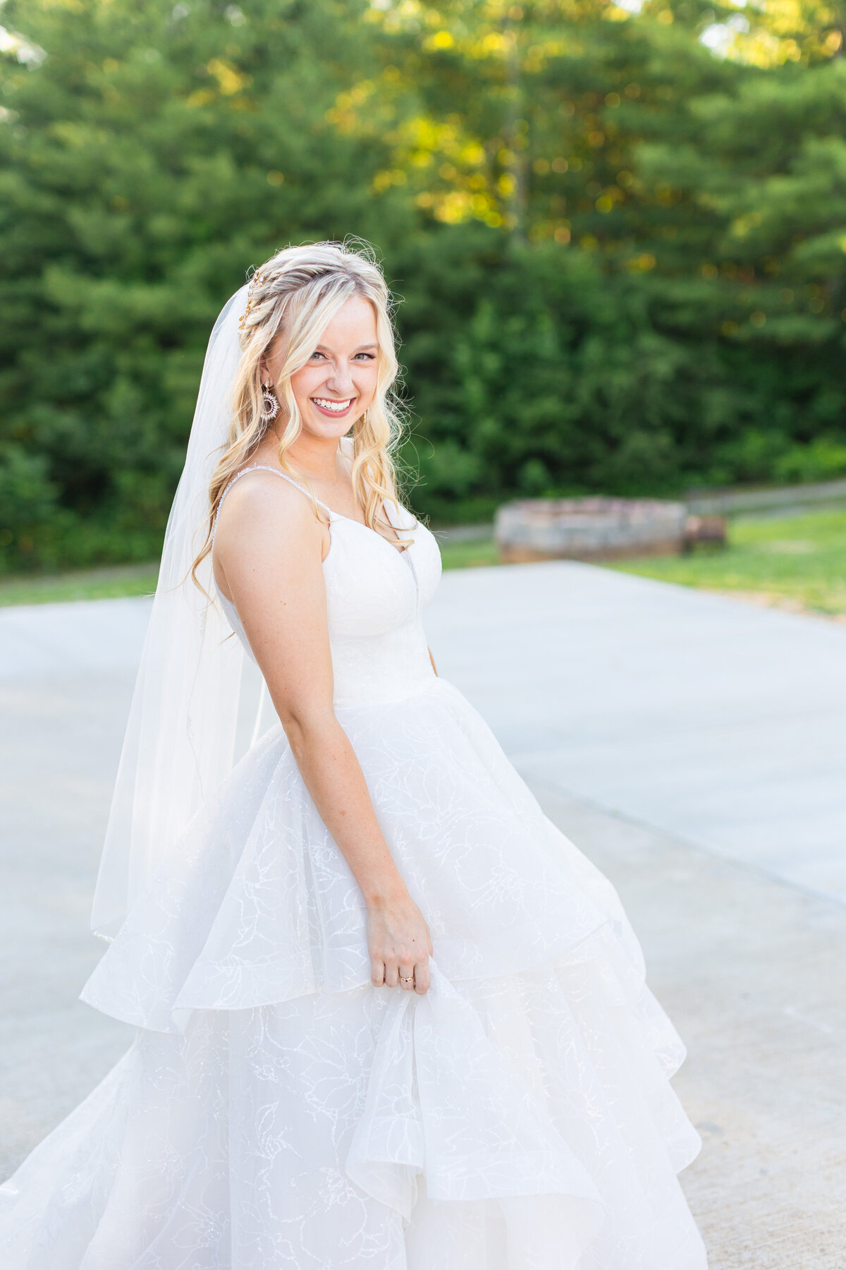 bride smiling and swinging her wedding dress