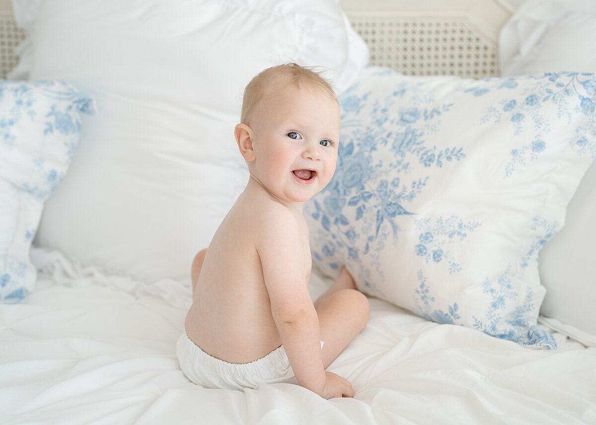 baby boy celebrating his first birthday photographed in a diaper cover on a daybed in brunswick ga