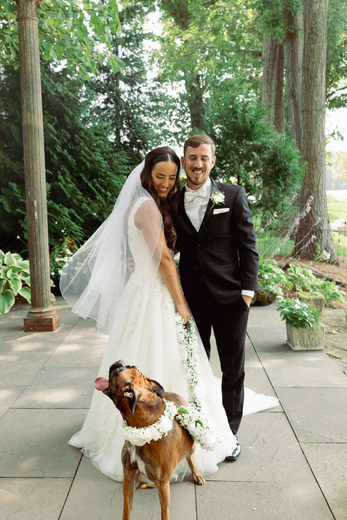 Bride and groom pose with dog during first look at New Jersey wedding 