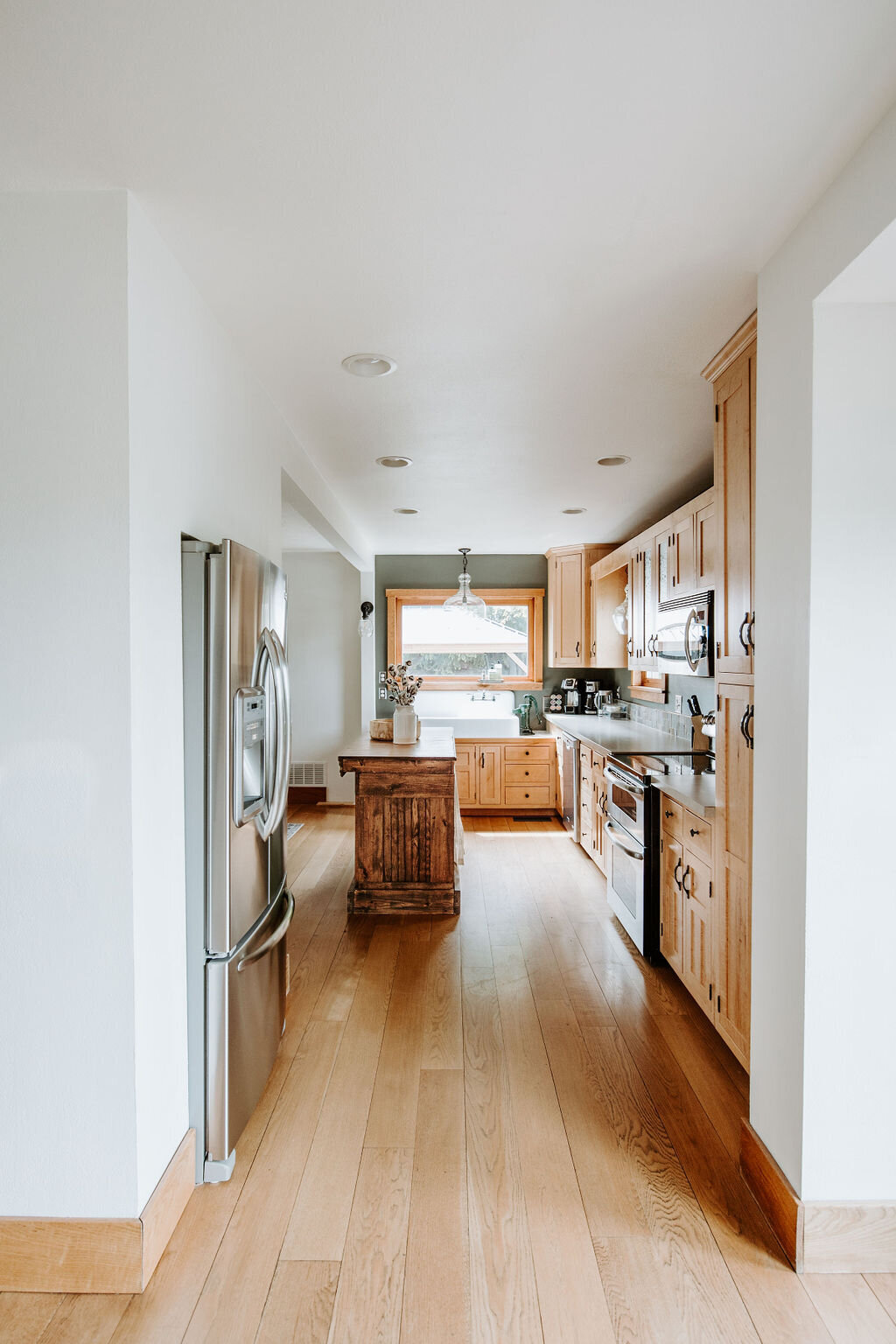 view of the kitchen and refrigerator in the modern farmhouse overnight accommodations at Willowbrook wedding venue