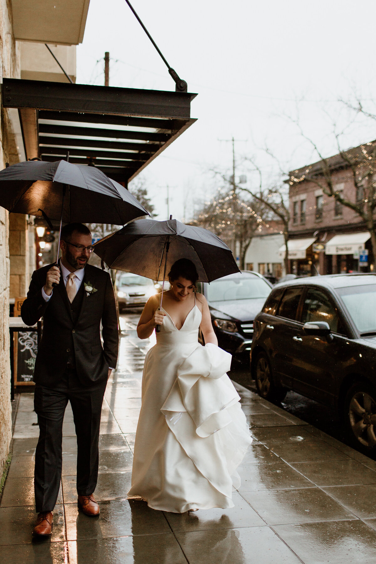 A moody candid of a couple on their rainy wedding day captured by Fort Worth Wedding Photographer, Megan Christine Studio