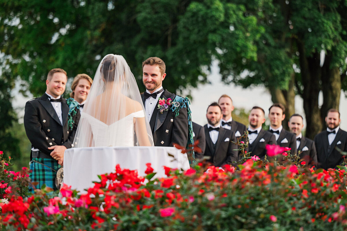 groom smiling at bride during wedding ceremony