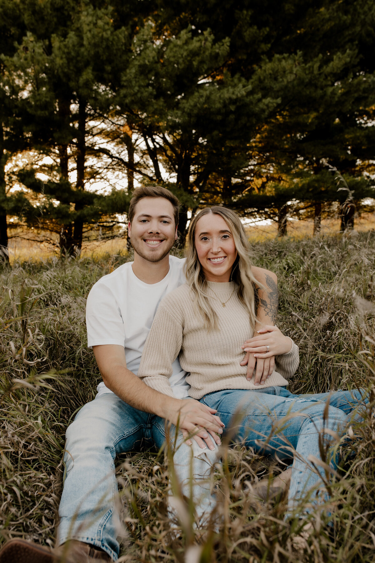 Couple's engagement session in Omaha during golden hour, surrounded by warm fall foliage – captured by Tori Nichole Photography. Authentic, romantic moments in a stunning autumnal setting, reflecting the beauty of the season and their love story.