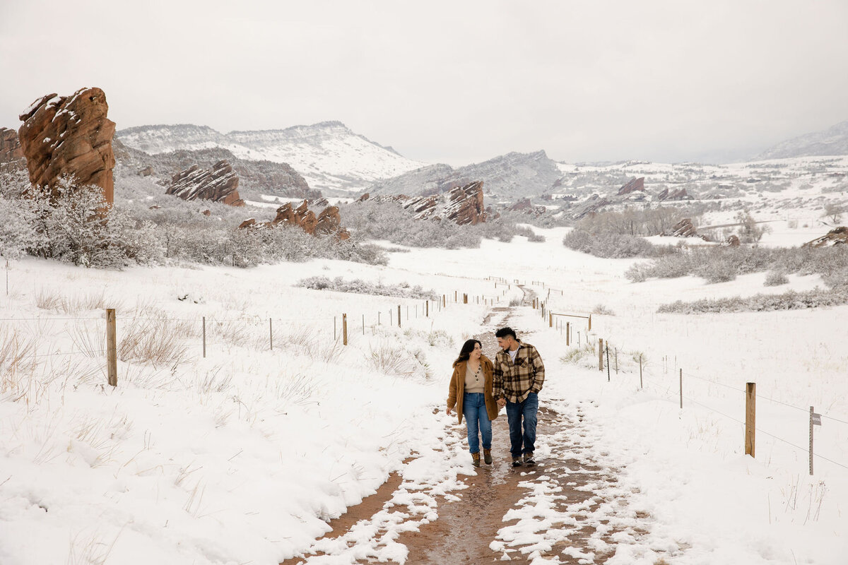 Couple explores Colorado snowy mountain trail during  their vacation photoshoot