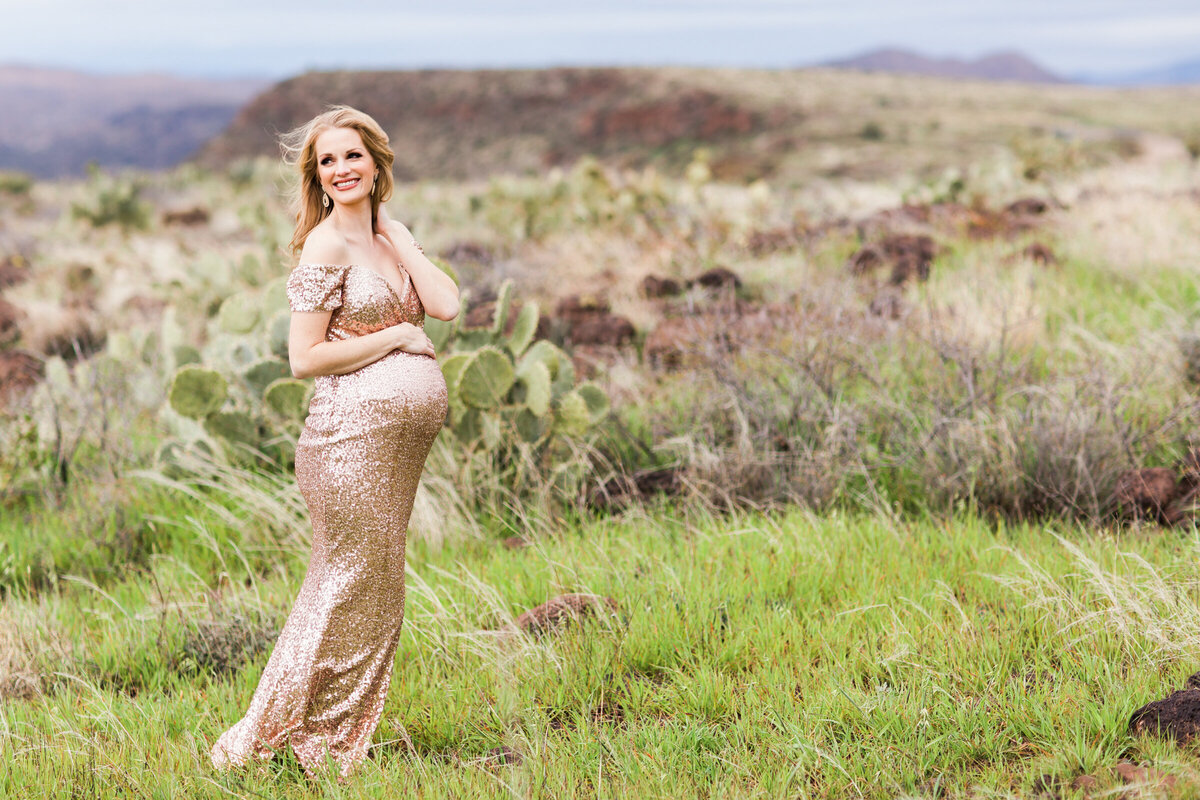 pregnant woman holding baby bump for maternity photography session
