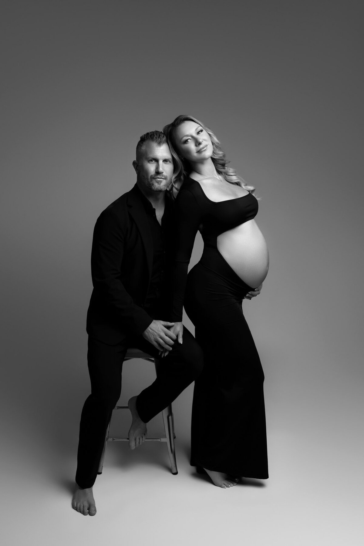 Romantic maternity silhouette by Leander maternity photographer with dramatic studio lighting