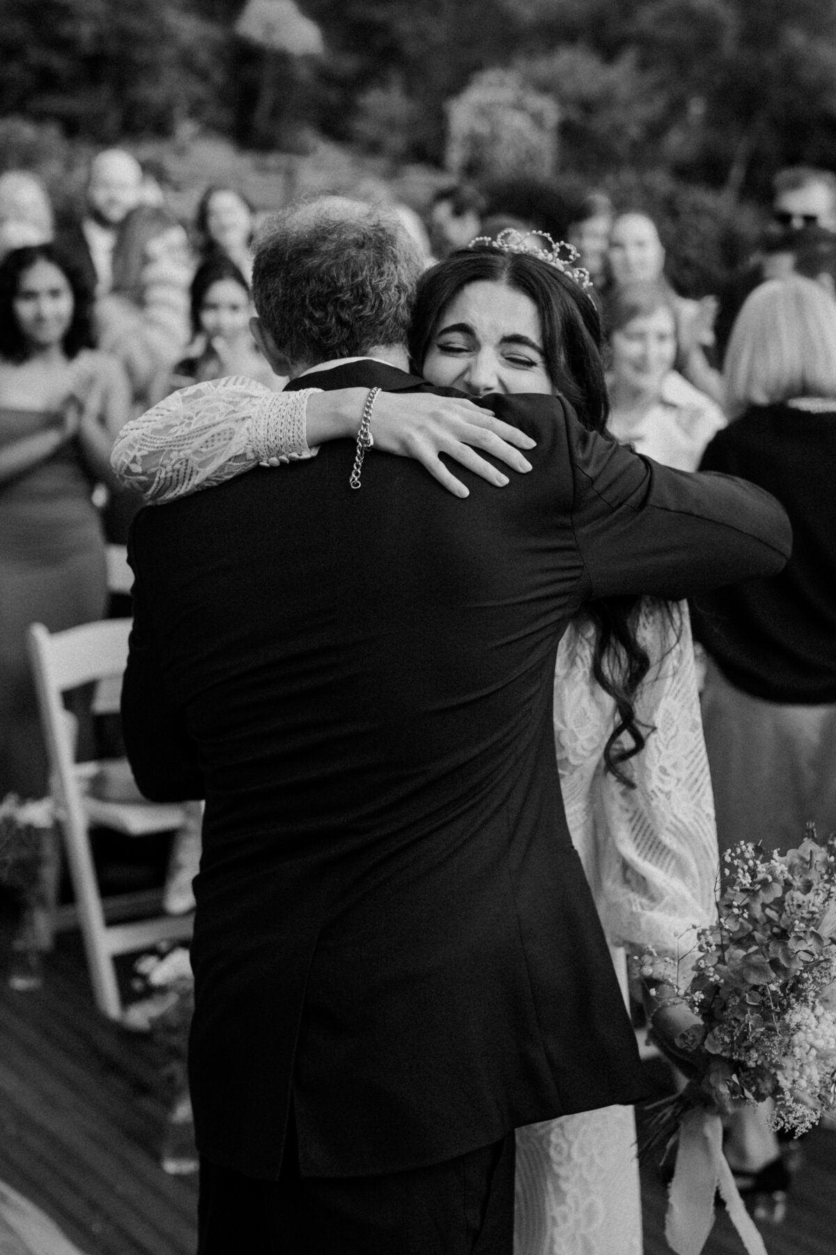 Bride hugging dad during ceremony at avalon castle 