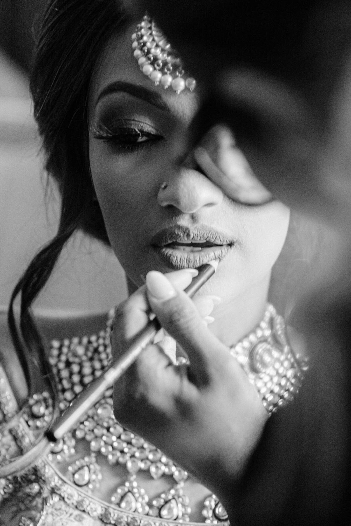 Bengali wedding photographer in Calgary captures bridal makeup application