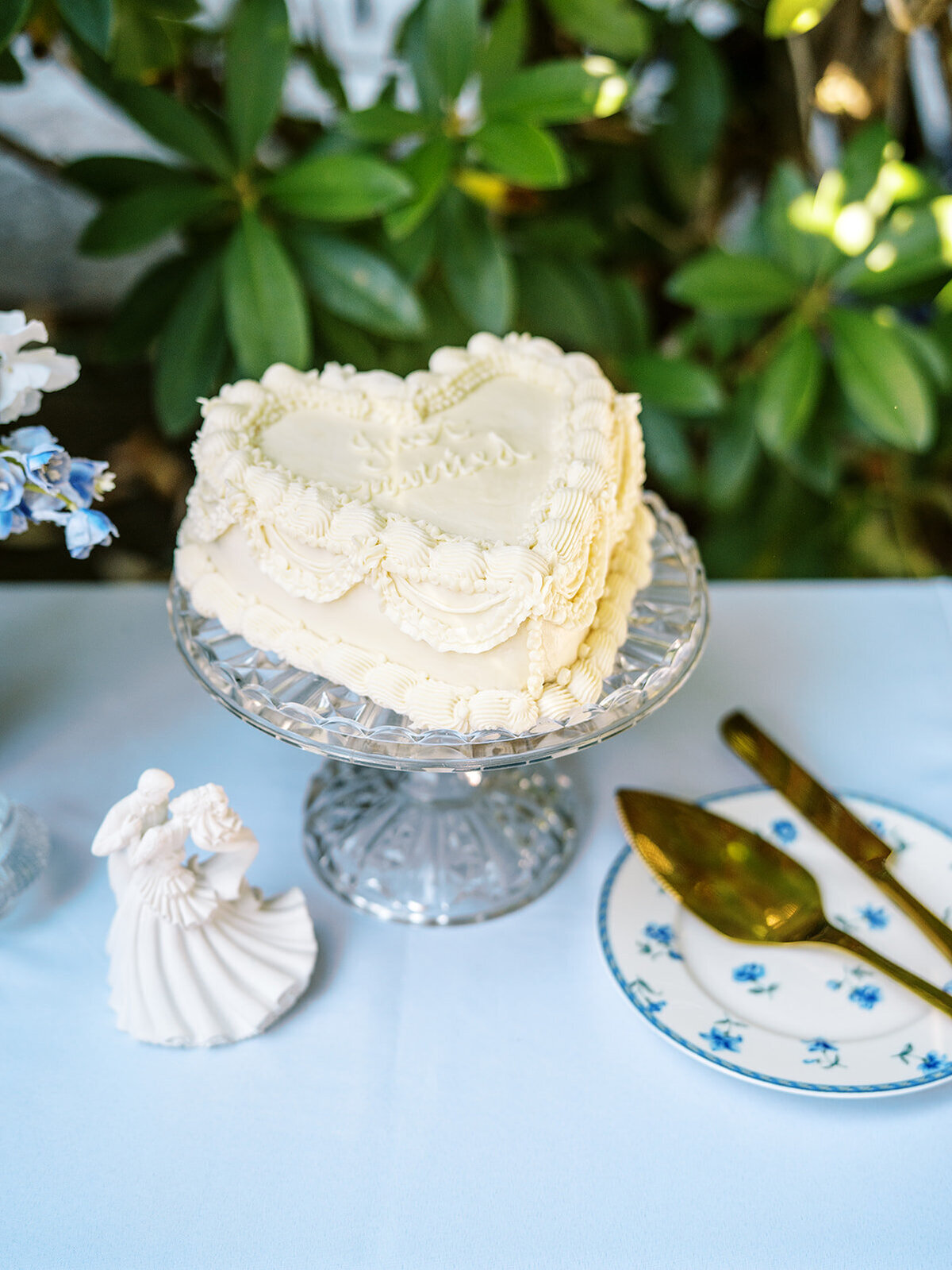 A wedding cake in the shape of a heart, representing a details shot captured by photographer Among the Oaks