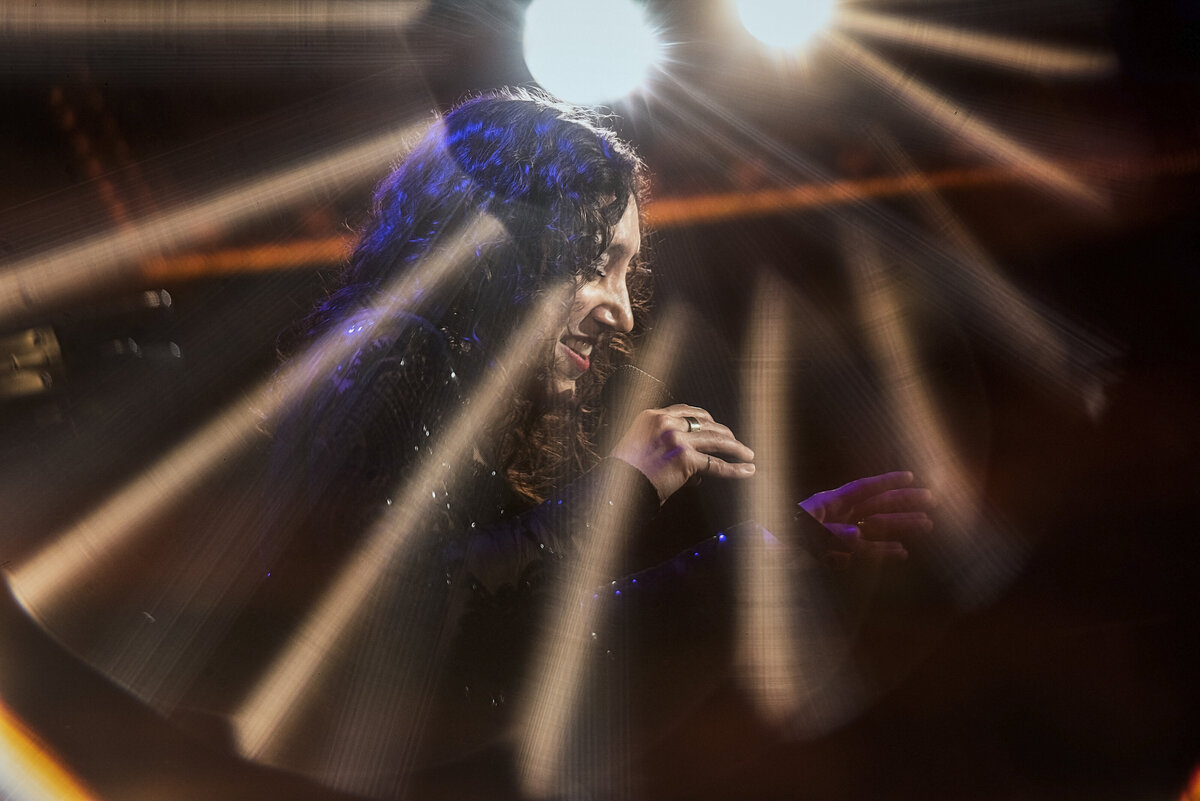 A woman singing with a spotlight on her