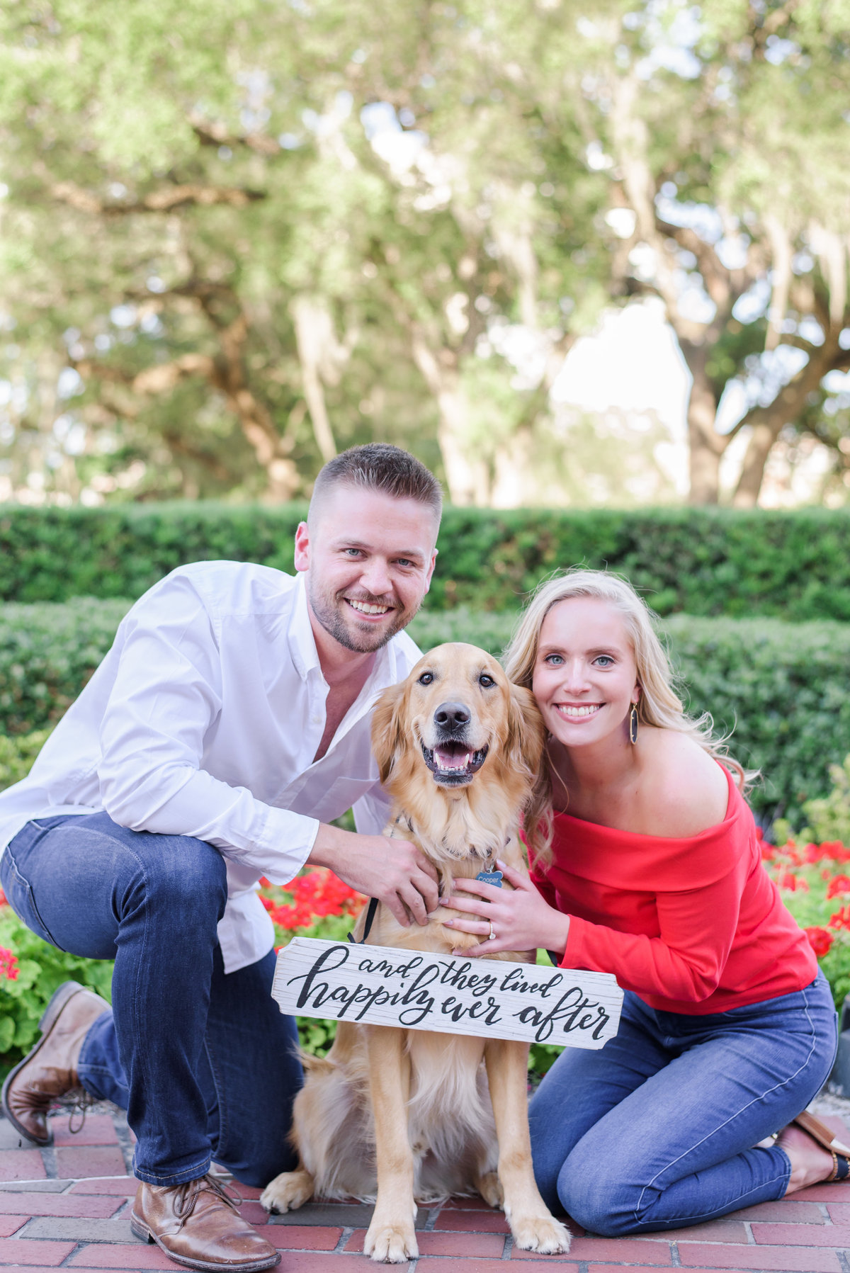 Couple use their golden retriever to announce their engagement on the campus of the university of Tampa