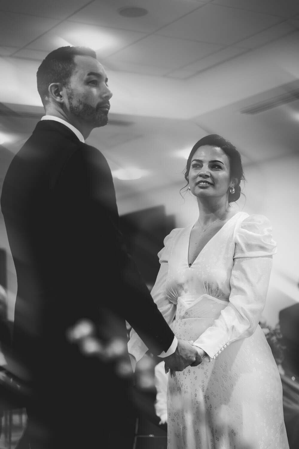 Bride and Groom hold hands at ceremony