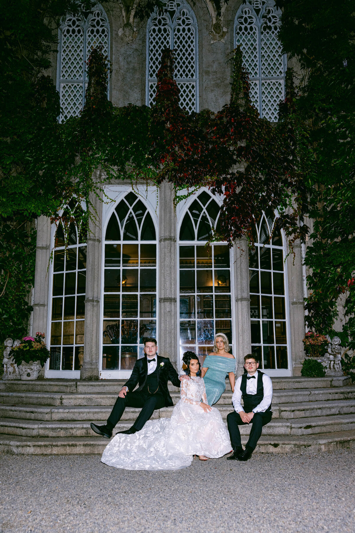 A wedding photo of the bride and groom posing for a photo with their friends at their wedding at luttrellstown Castle
